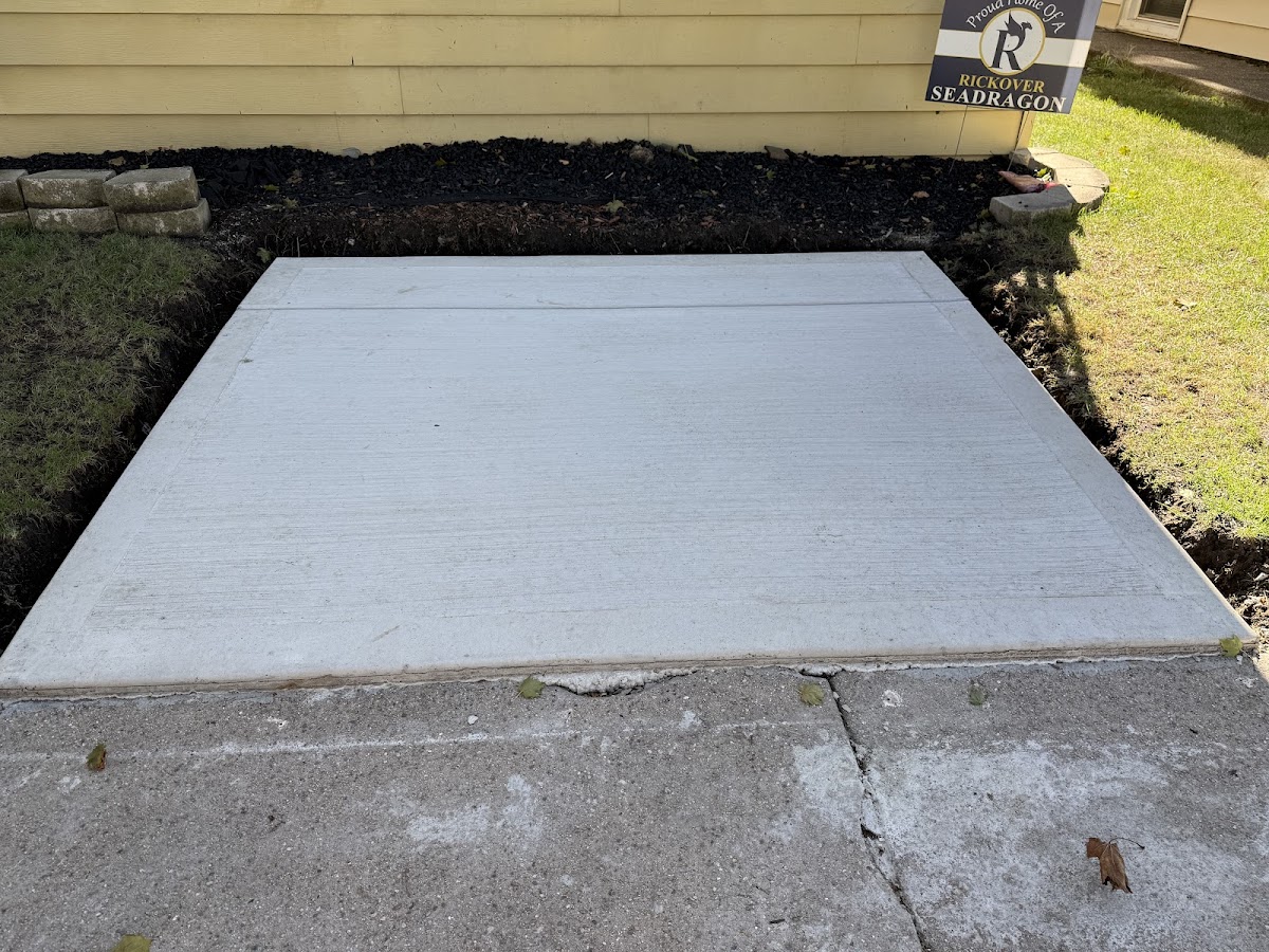 Fresh concrete slab next to a garage